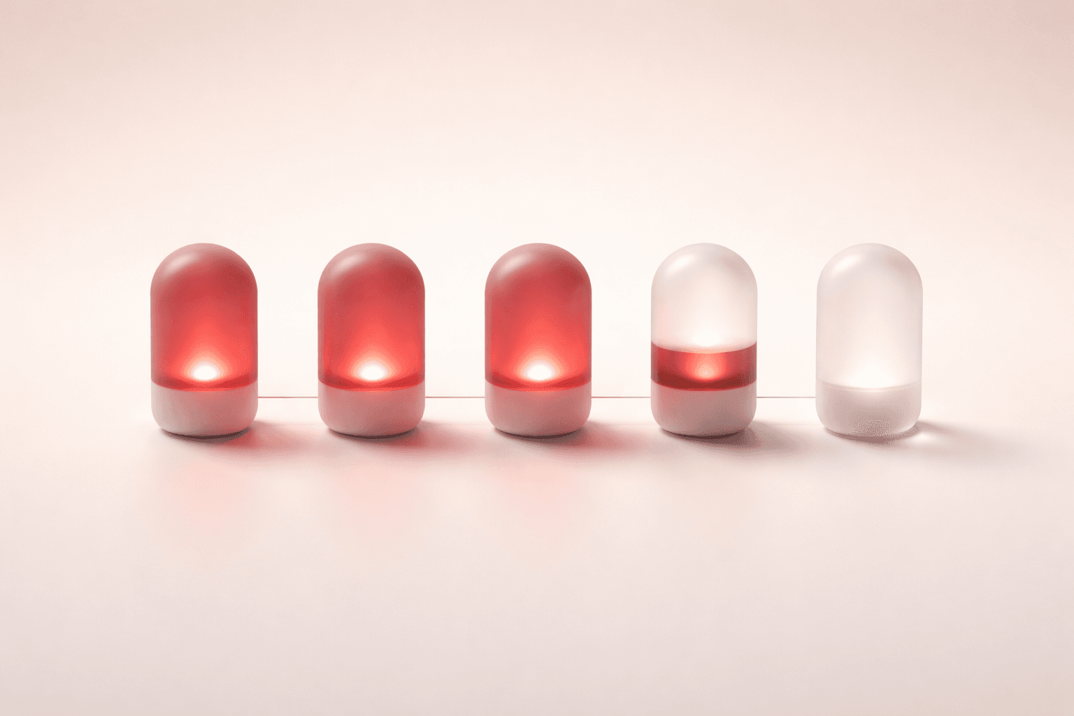 Five capsule pills in a row, three filled with oxblood — stand-in for step-by-step brief progress.